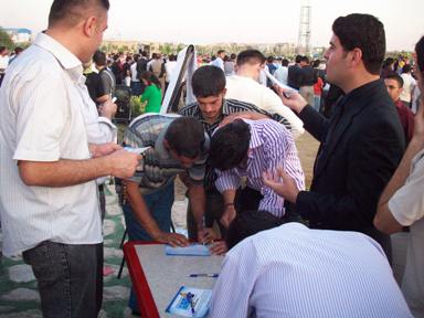 Iraqis sign a petition in support of KYFF at Aynda Youth Festival.