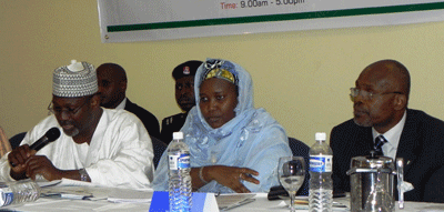 Jega (left) addresses political party representatives as INEC commissioners Hajiya Amina B. Zakari (center) and  Barr. Philip Umeadi (right) listen.