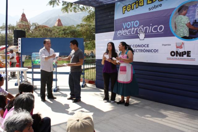 Voters participate in an e-voting demonstration during an educational fair.