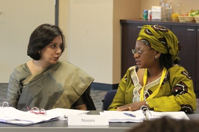 Firdaus (left) talks with Asah Epse Moma Bernadette, from Cameroon, at workshop to develop the Women’s Leadership School initiative.