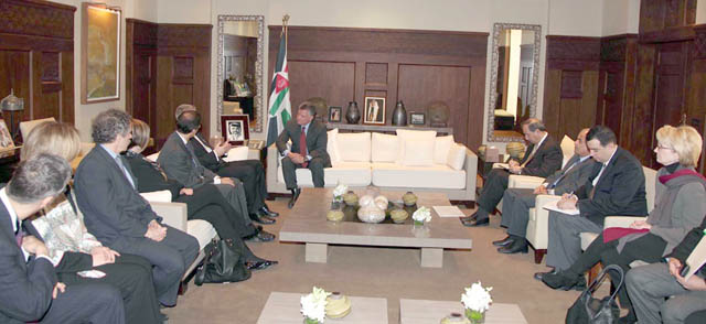 His Majesty King Abdullah meets with international monitors of the just ended election process in Jordan, in Amman on Thursday (Petra photo)