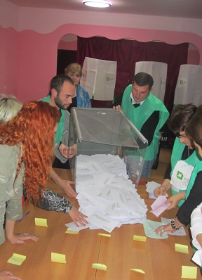 Ballots are poured out onto a table for counting.