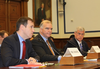 Mastic (left) testifies.