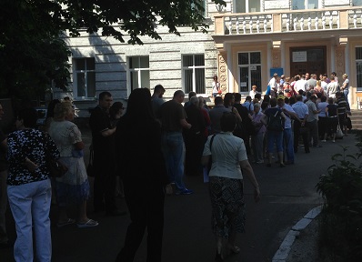 Voters wait in a long line to cast their ballots.