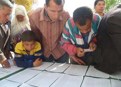 Voters look for their names on voter lists during Tunisia’s 2011 elections.