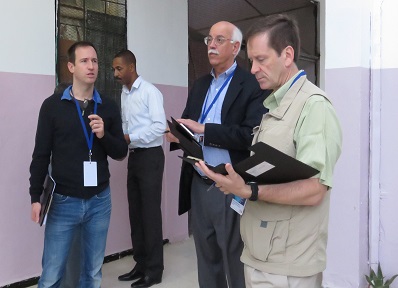 IRI leadership team discuss their observations at a polling station.