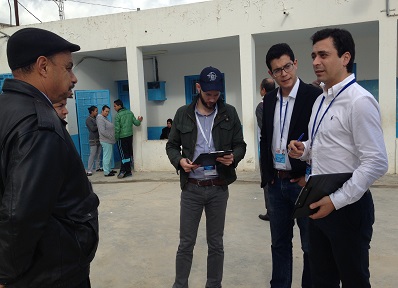 Vales (right) talks to a polling official.