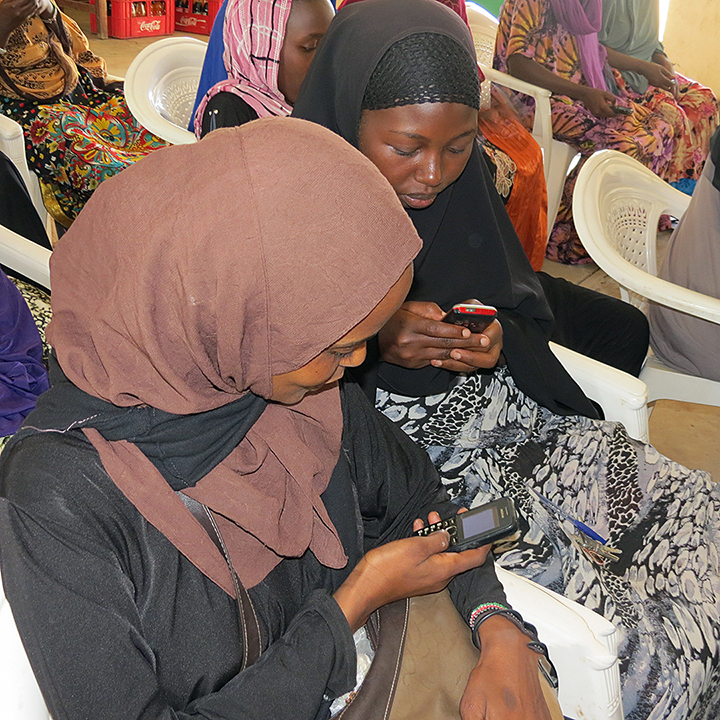 Women test out the SMS system.