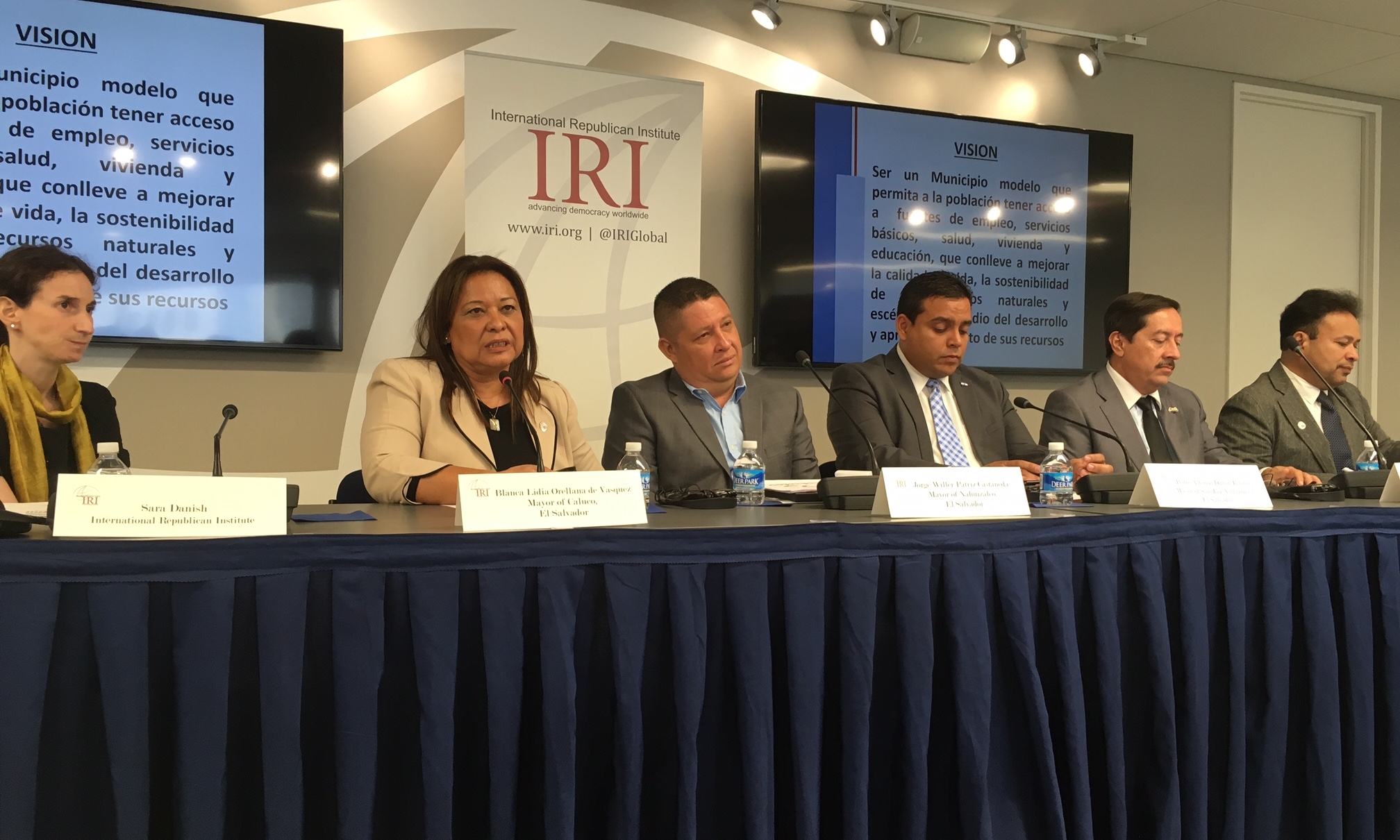 IRI Program Manager Sara Danish, Caluco Mayor Blanca Orellana, Nahuizalco Mayor Jorge Willer Patriz, San José Villanueva Mayor Pedro Durán, and COMURES representatives Ronny Romero and Luis Peña participate in a panel discussion at IRI.  