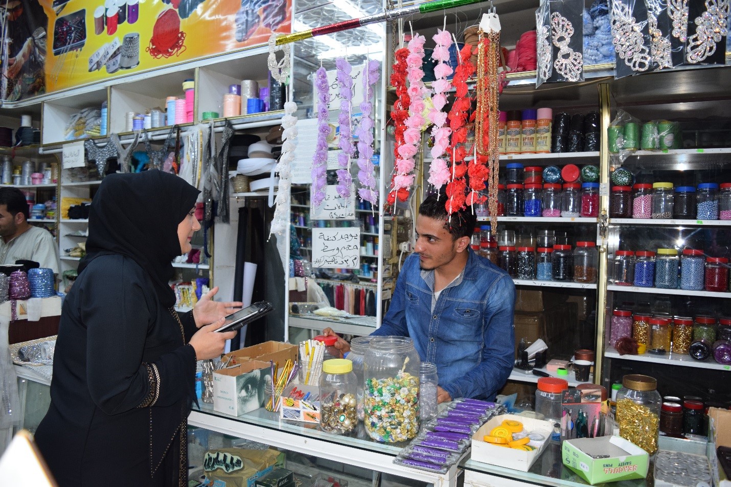IRI Citizen Committee member surveying a shopkeeper about the local issues he cares most about