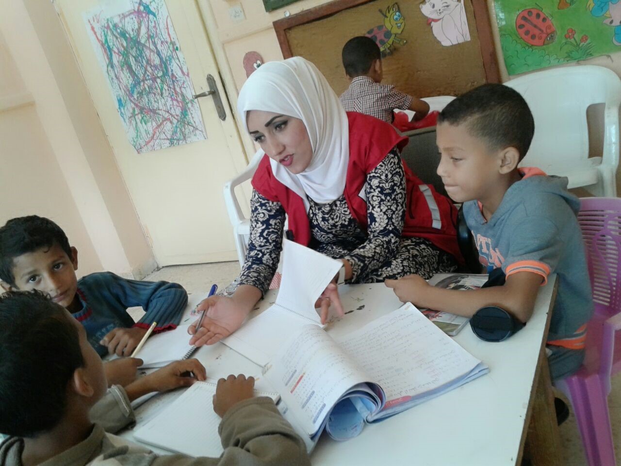 Dina volunteering with the Jordan National Red Crescent Society to help children with their homework