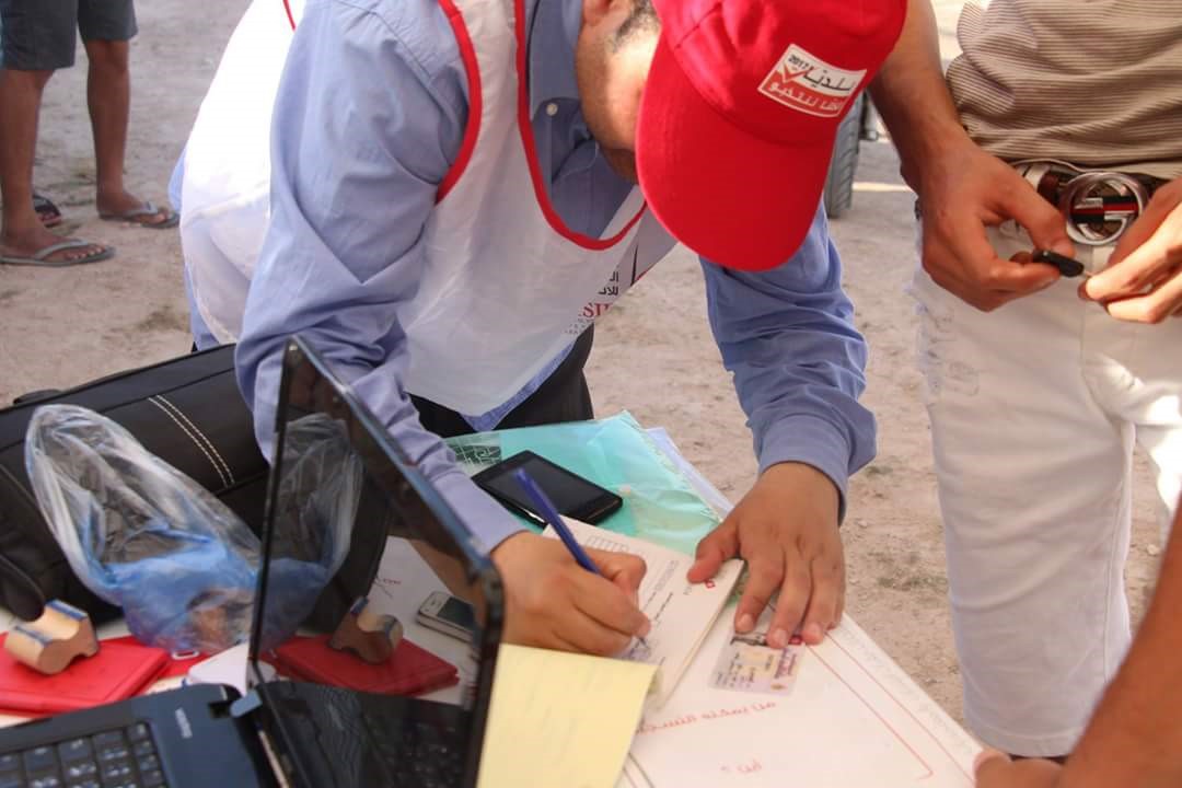 A representative of the Independent High Authority for Elections registers a new voter at a youth sporting event in Medenine governorate.