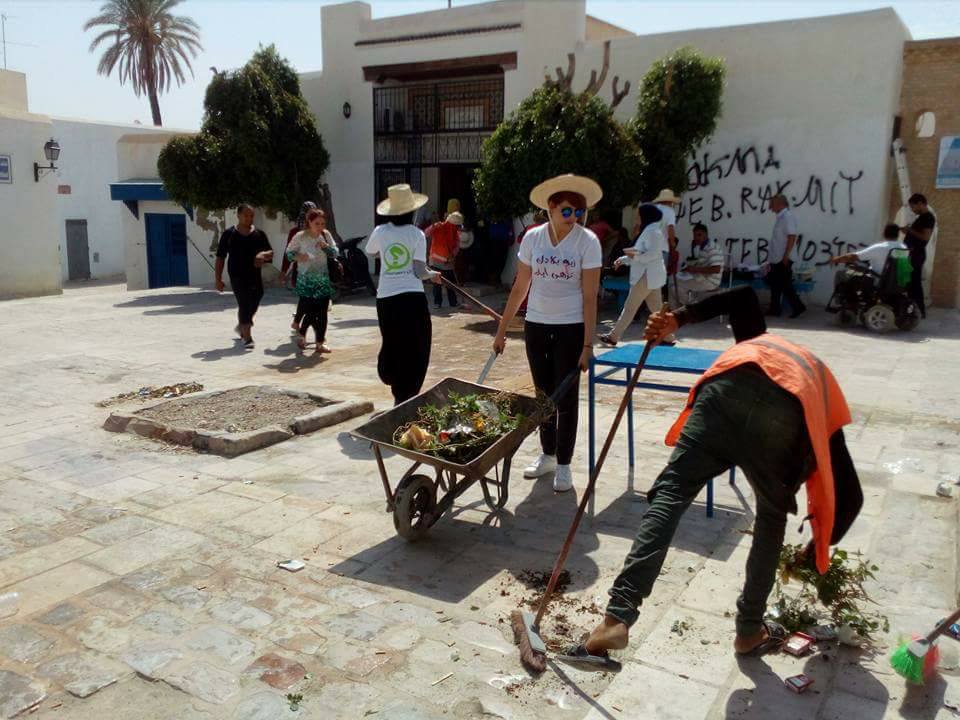 Volunteers participate in a community clean up and voter registration activity in Kairouan, Kairouan.
