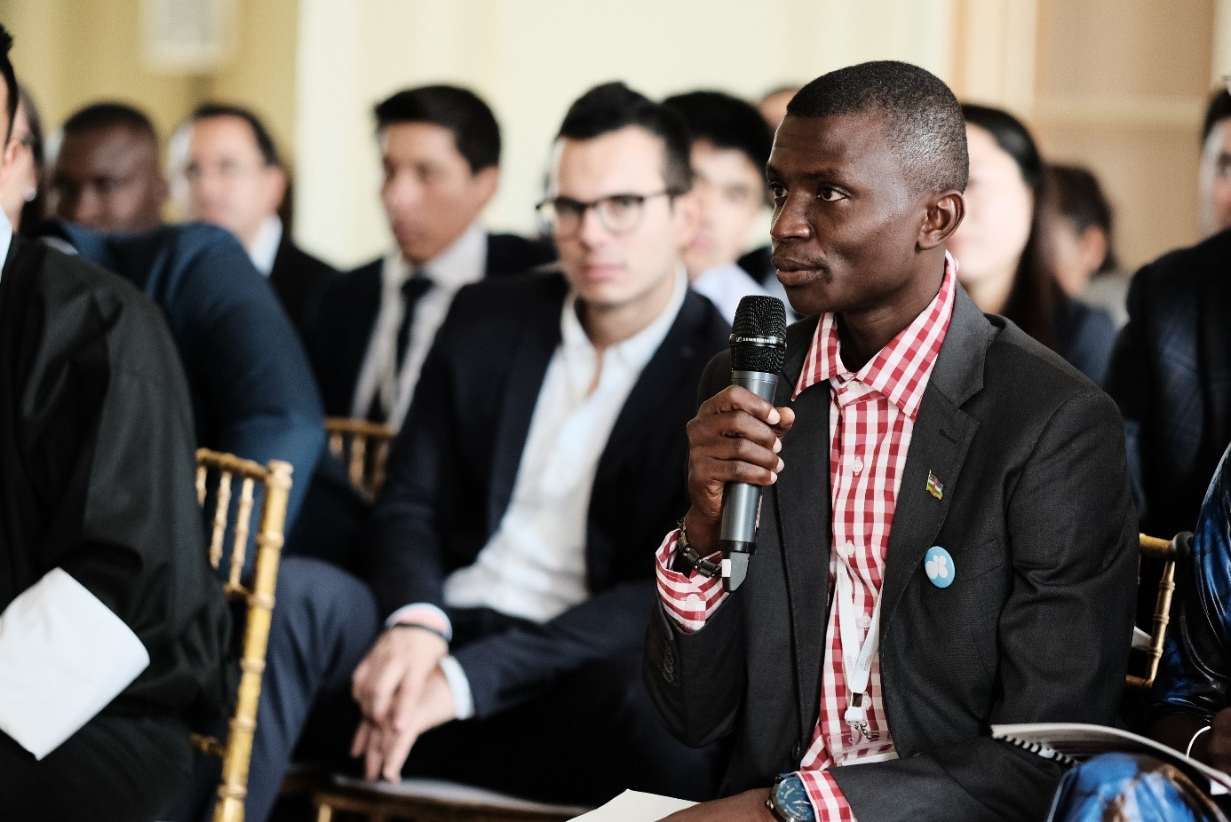 A man talks into a microphone at a meeting