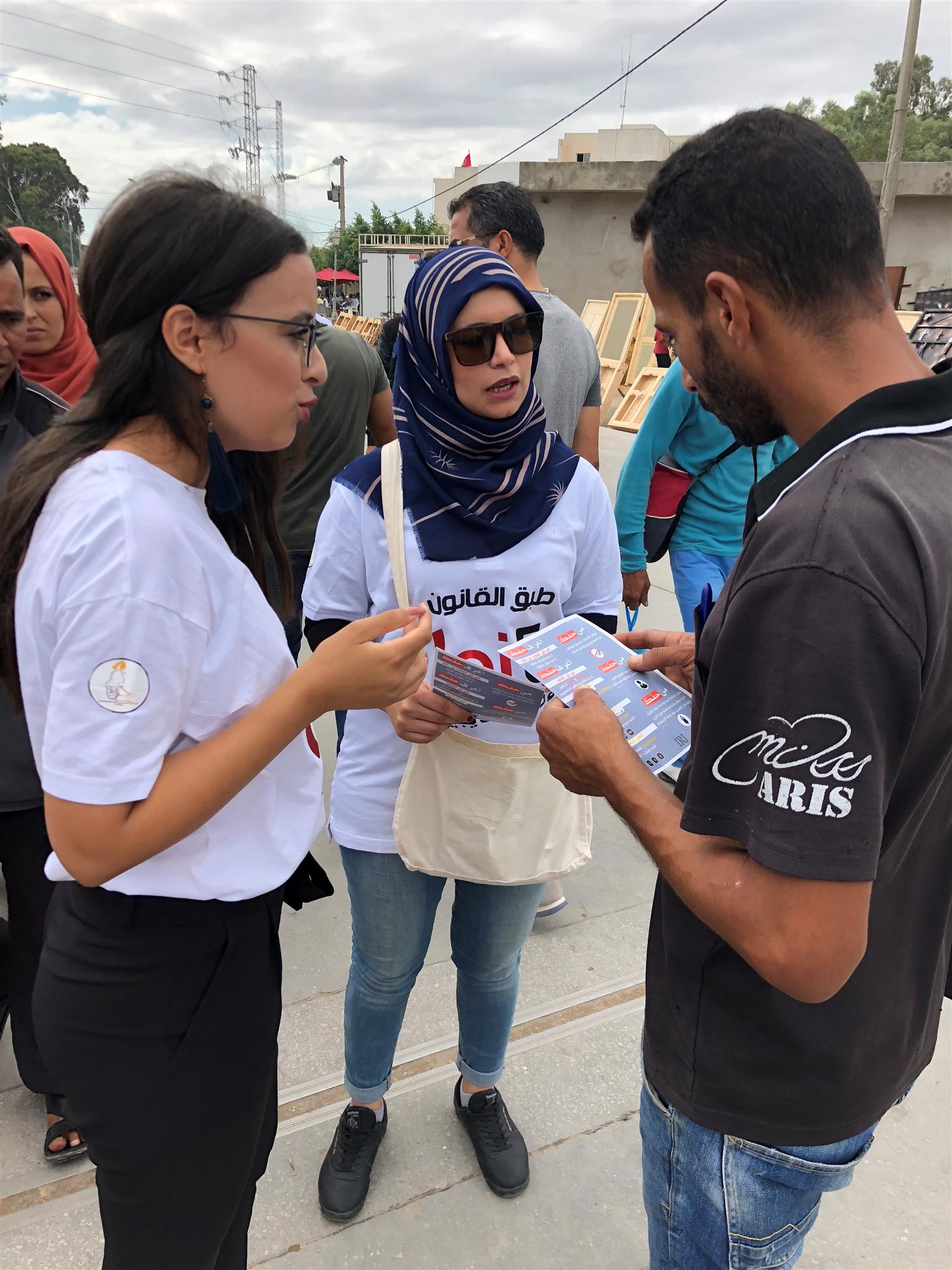 Ladies talk to a man outside