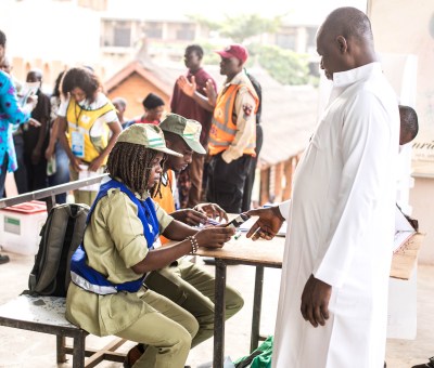 A man stamping his thumb to vote