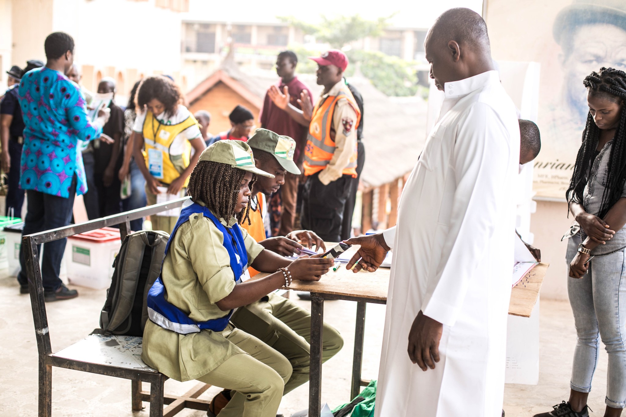 A man stamping his thumb to vote