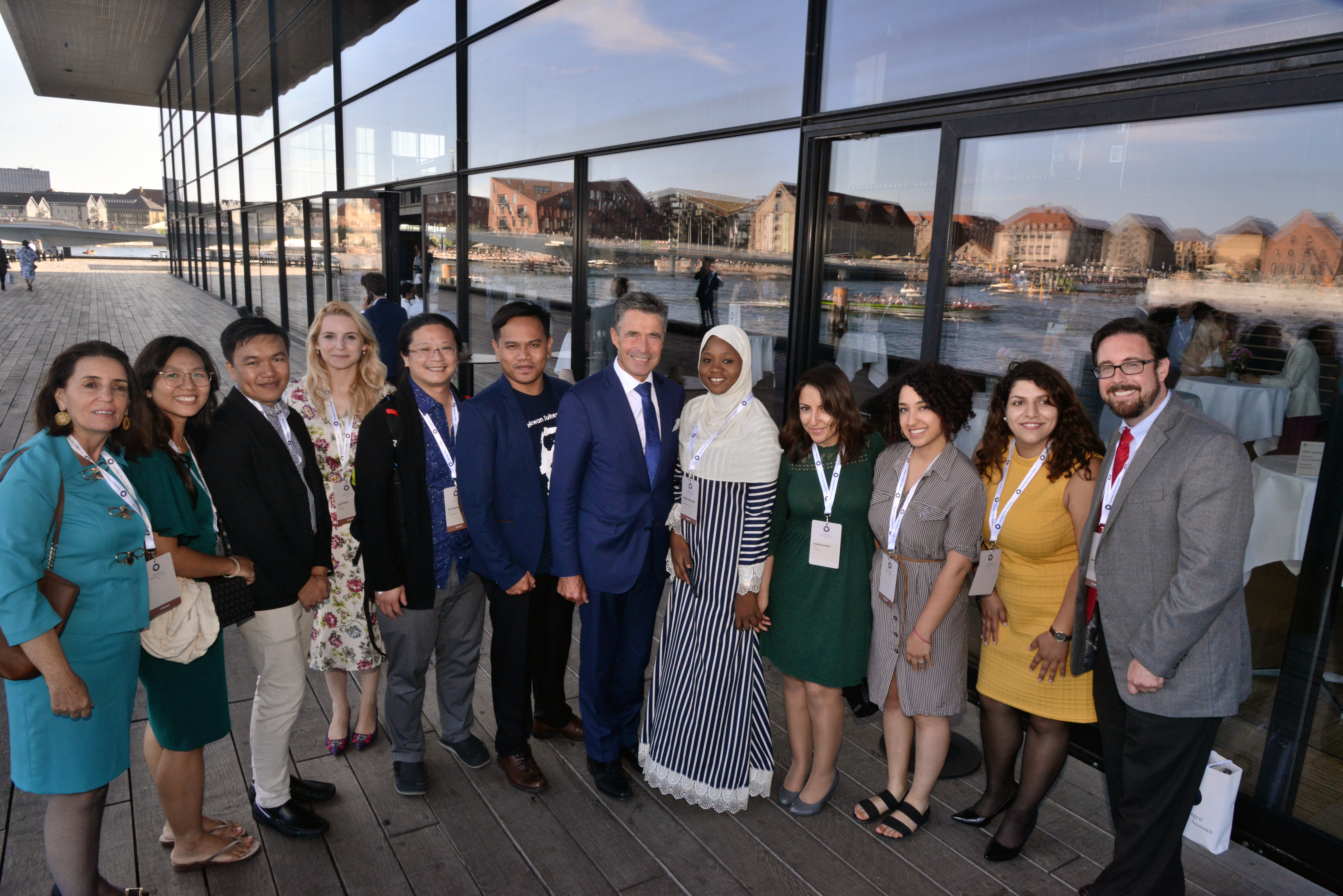 Gunawan (6th from the left), the founder of the Sikola Mombine, a political training school in Indonesia’s Central Sulawesi Province, poses with former NATO Secretary General Anders Fogh Rasmussen (center) and other participants at the 2019 Copenhagen Democracy Summit. 
