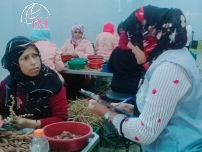 An IRADA volunteer speaks with factory employees, many of whom who are illiterate women, about the importance of voting and how to register to vote. 