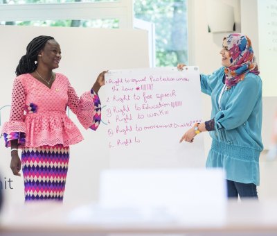 Two women present a presentation