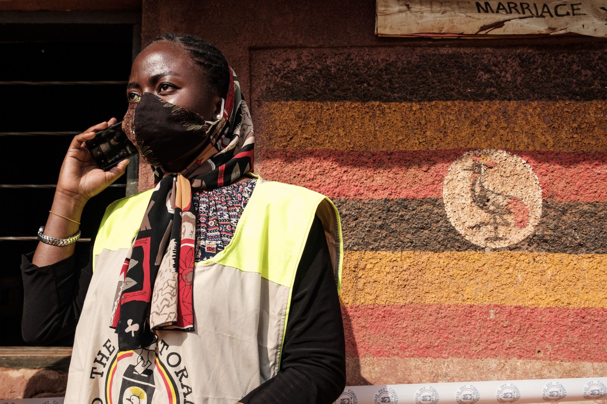 Uganda poll worker on phone