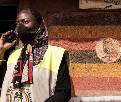 Uganda poll worker on phone