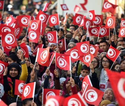 Tunisians wave national flags