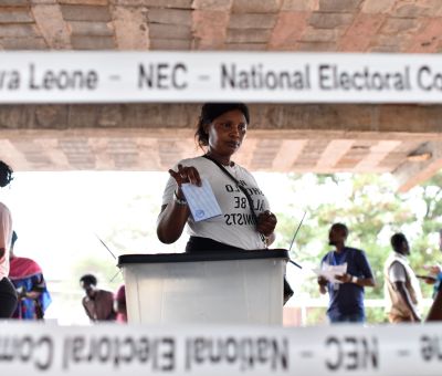 A woman casts her vote at a polling station in Sierra Leone