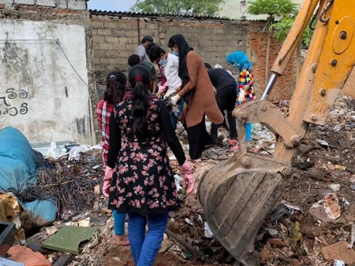 ELA members demonstrating 'democracy at work' while clearing a community dumping ground in coordination with local government authorities.