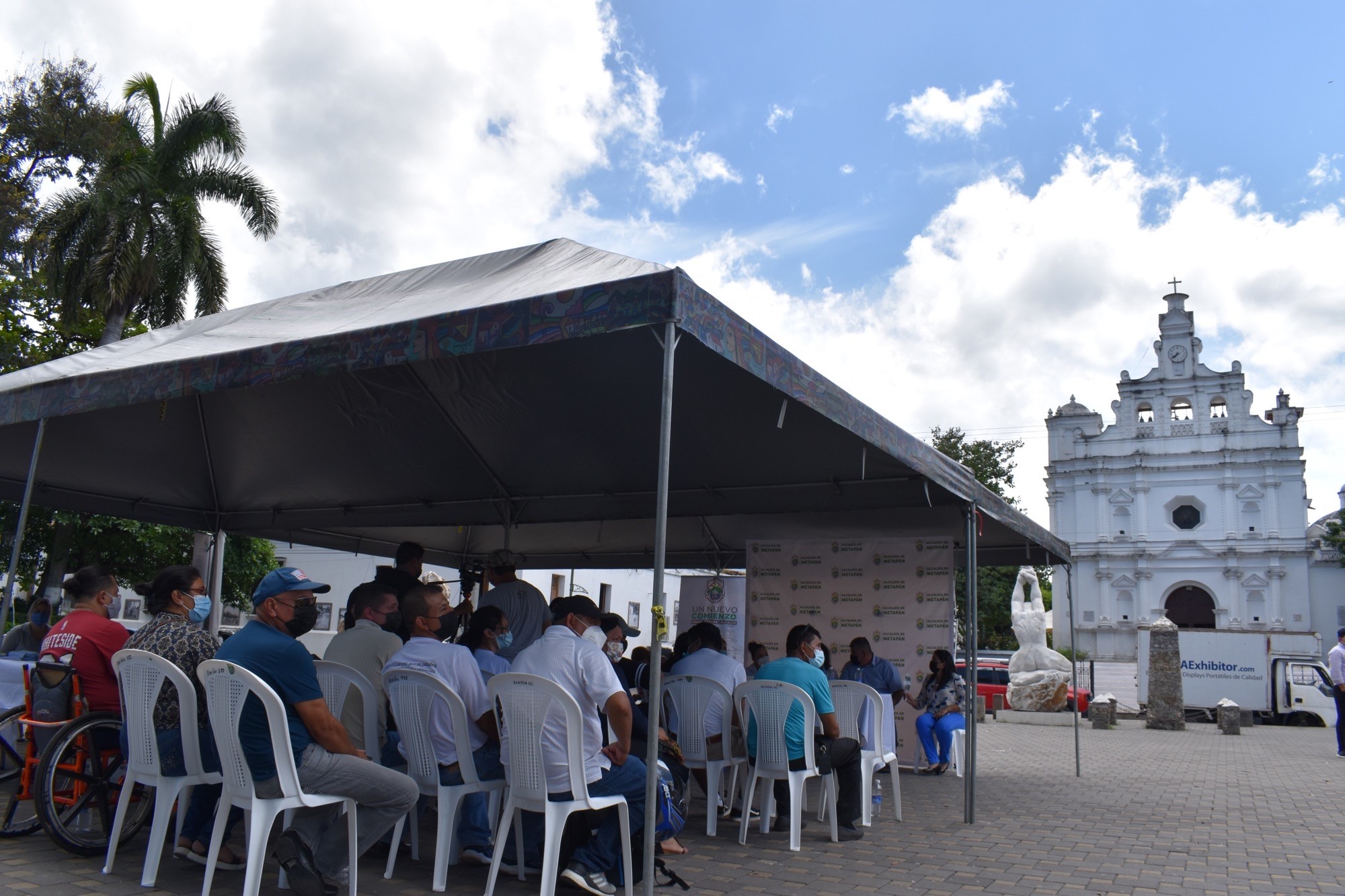 A group sits outside a church in El Salvador