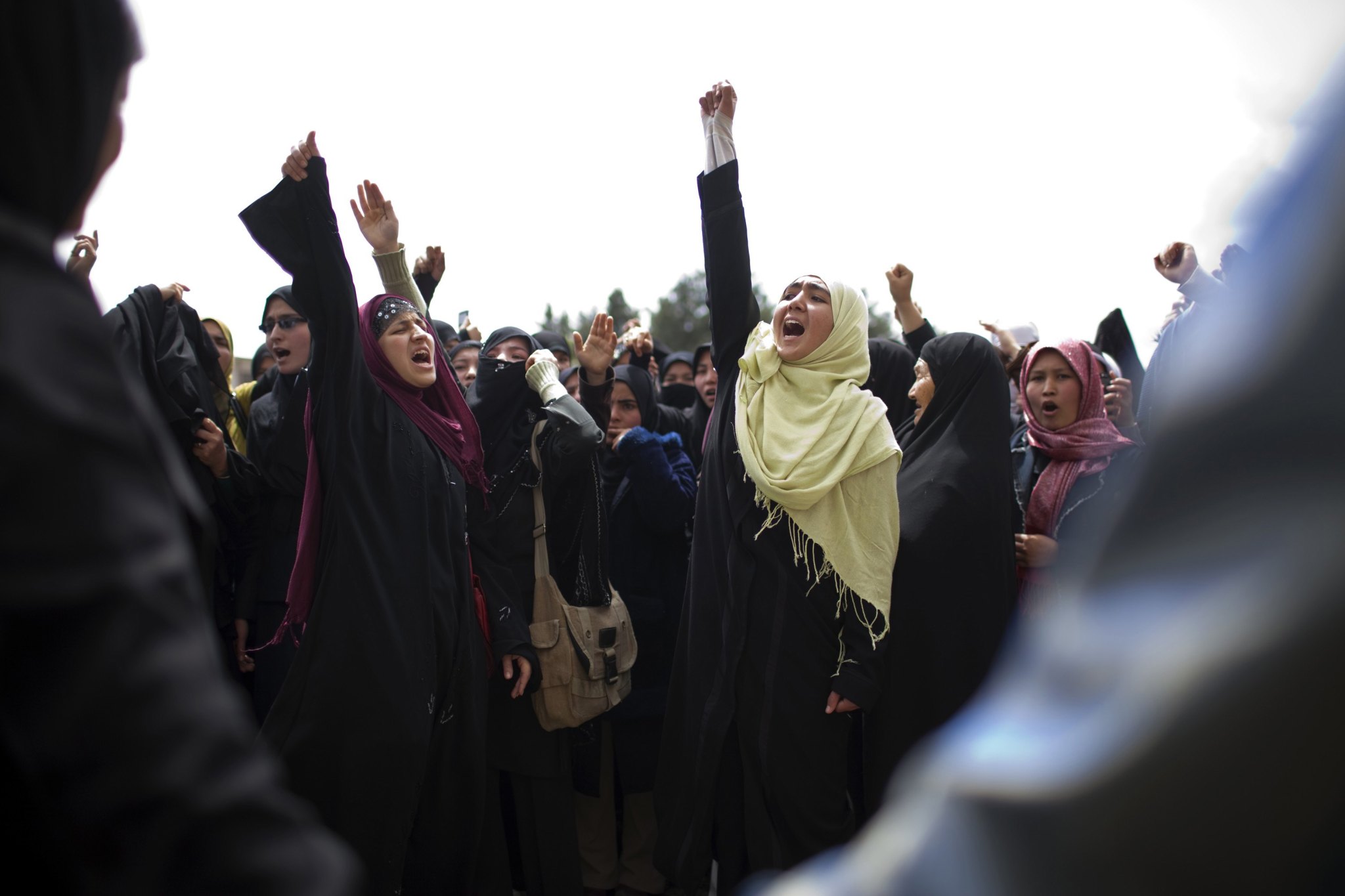 Women holding their fist in the air to protest a new family law in Afghanistan