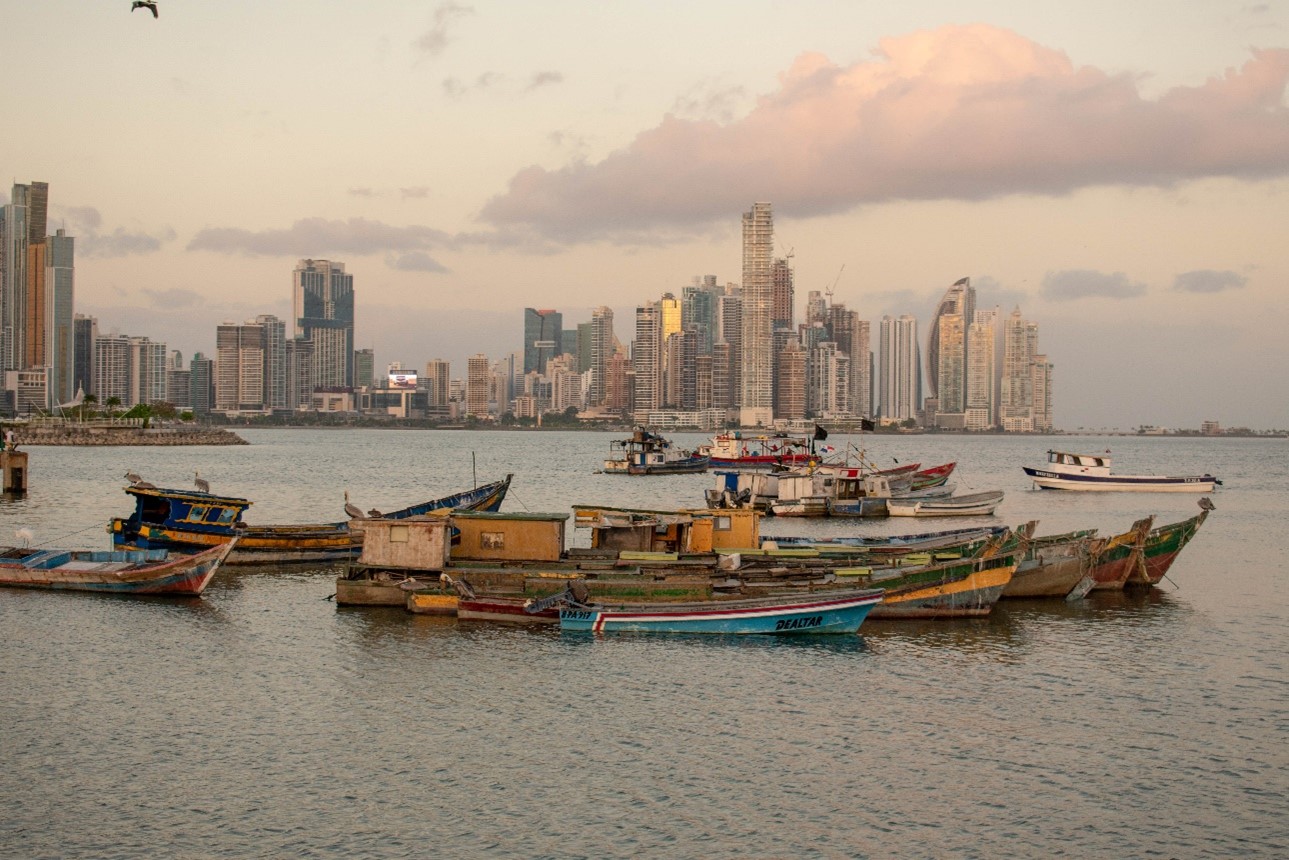 Boats sit in the water outside a large city in Panama