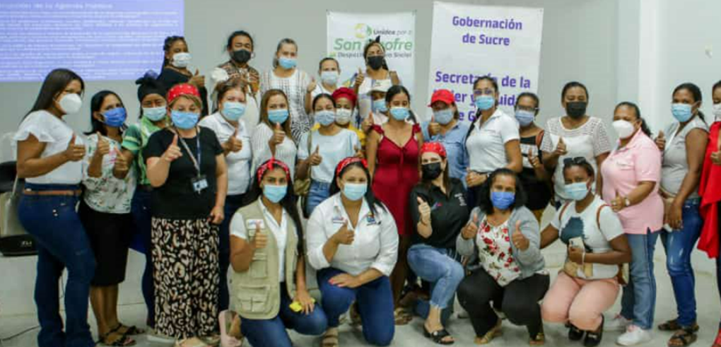 A group smiles for a picture to promote empowering women