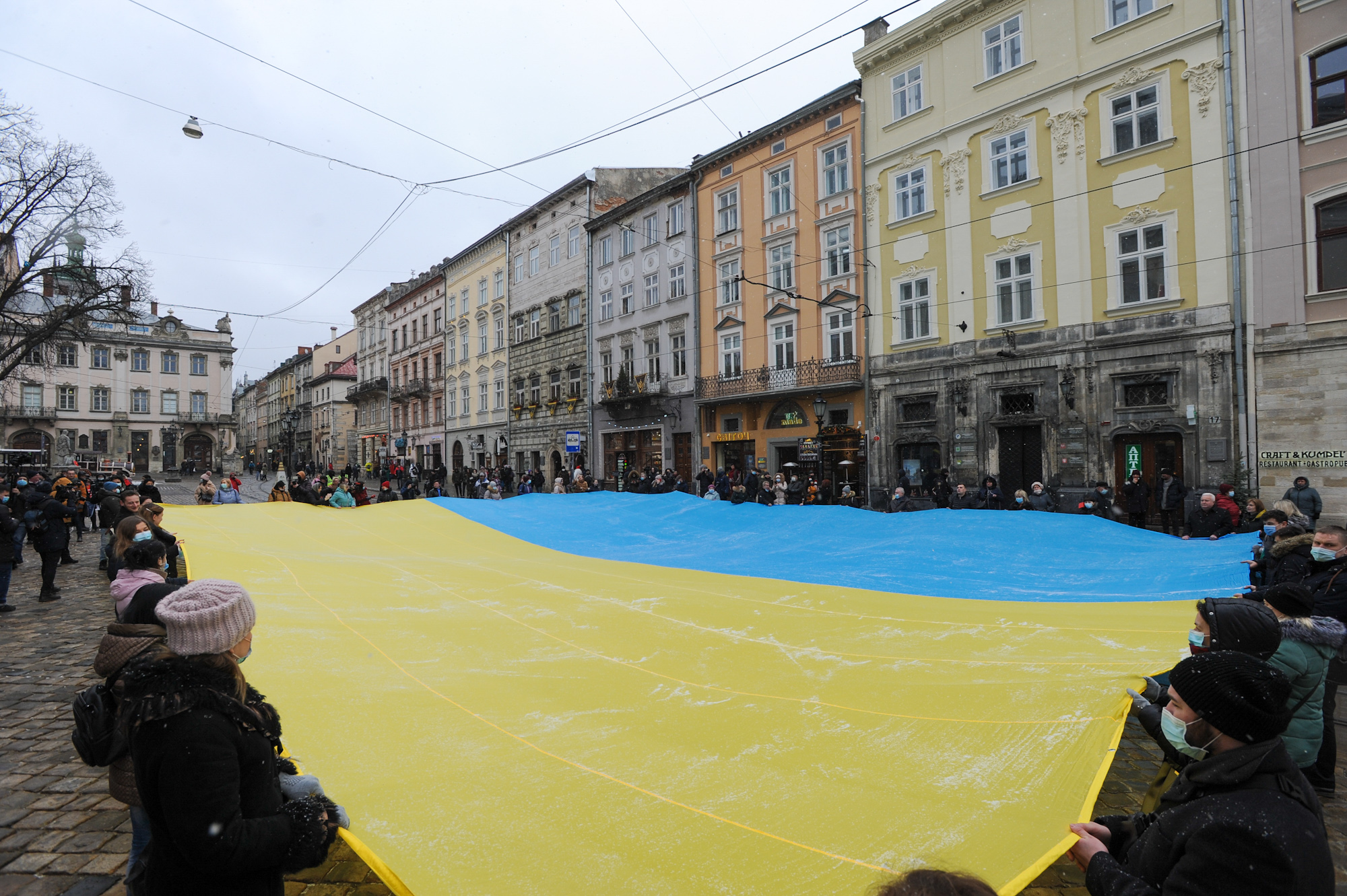 Ukrainians holding large flag