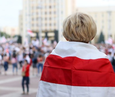 Woman wrapped in Belarusian flag