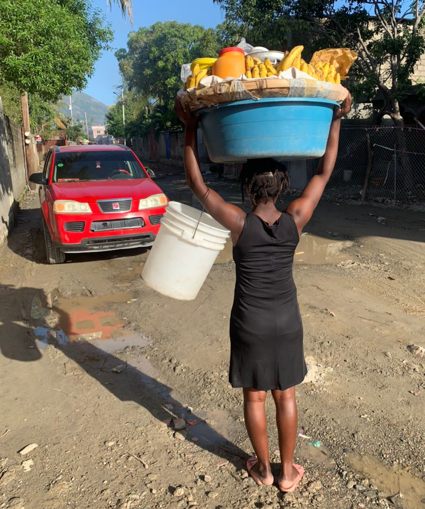 Woman carries fruit in Haiti