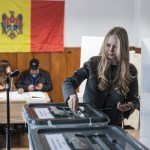 Woman votes at voting booth in Moldova