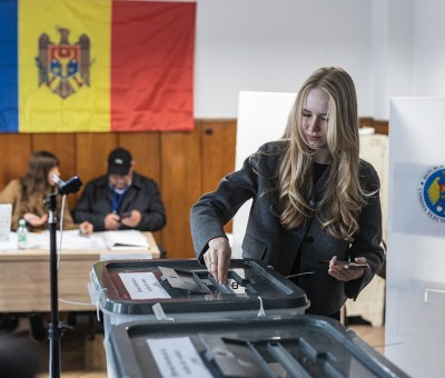 Woman votes at voting booth in Moldova